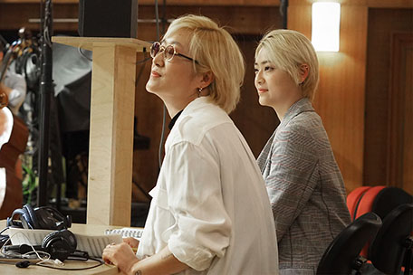 Composer Hye Seung Nam next to assistant Su Bin Ahn.